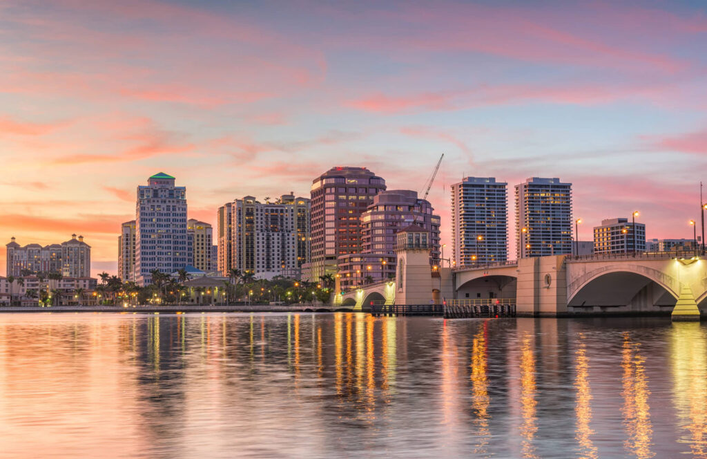 West Palm Beach skyline at sunset reflected over the waterfront